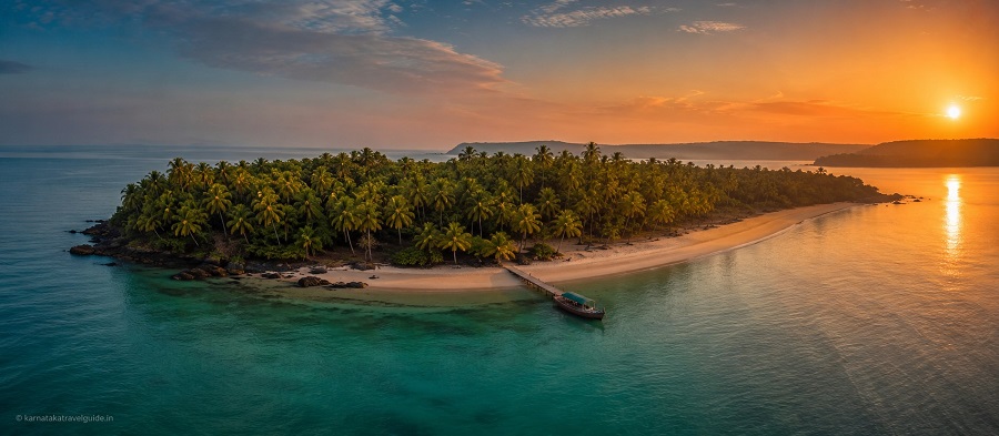 Devbagh Beach Resort — private island at sunset, turquoise Arabian Sea Karnataka coast