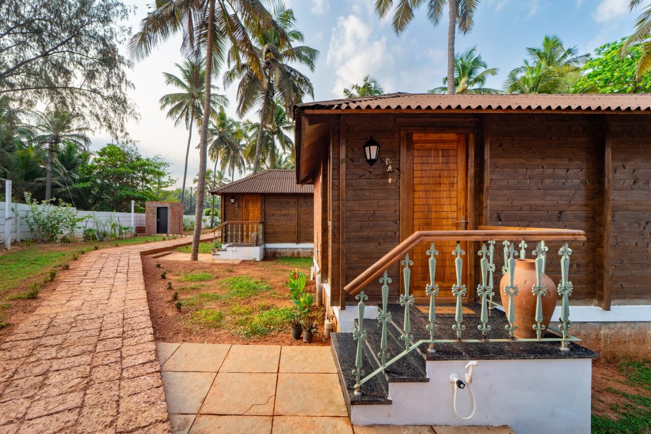Cottage entrance with steps and decorative railing at Miraya by the Beach