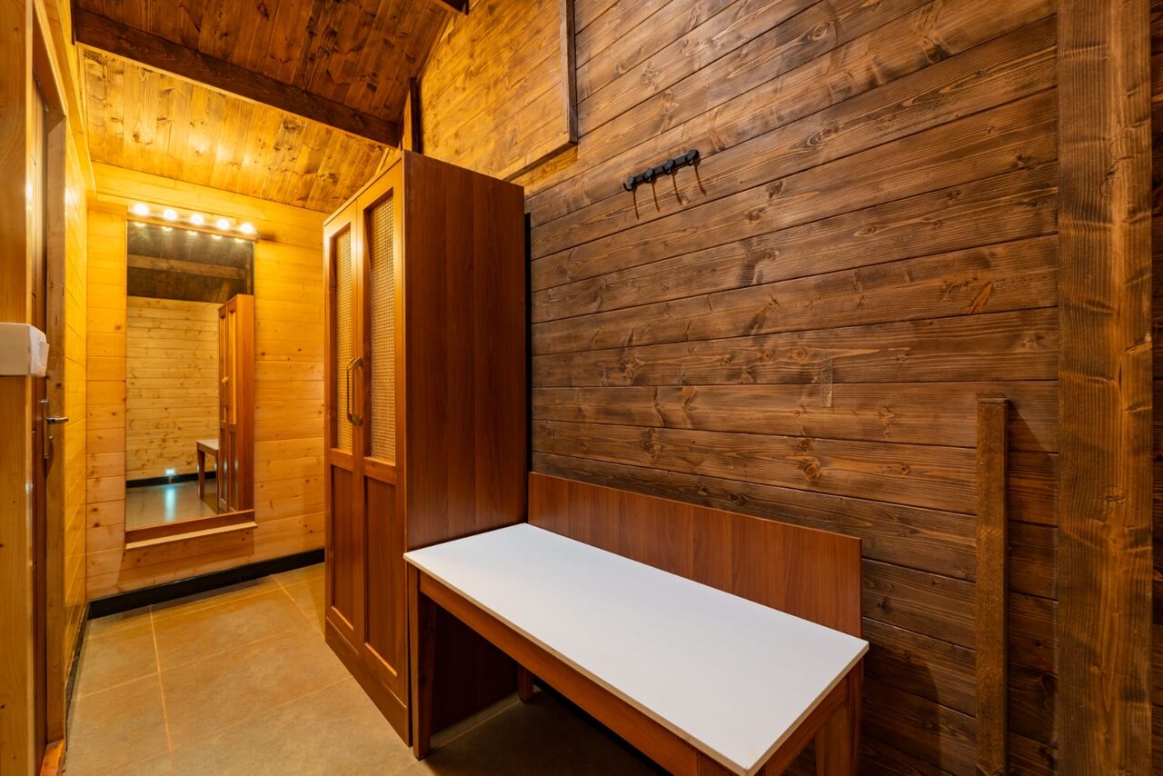 Wooden wardrobe and dressing area inside a cottage at Miraya by the Beach