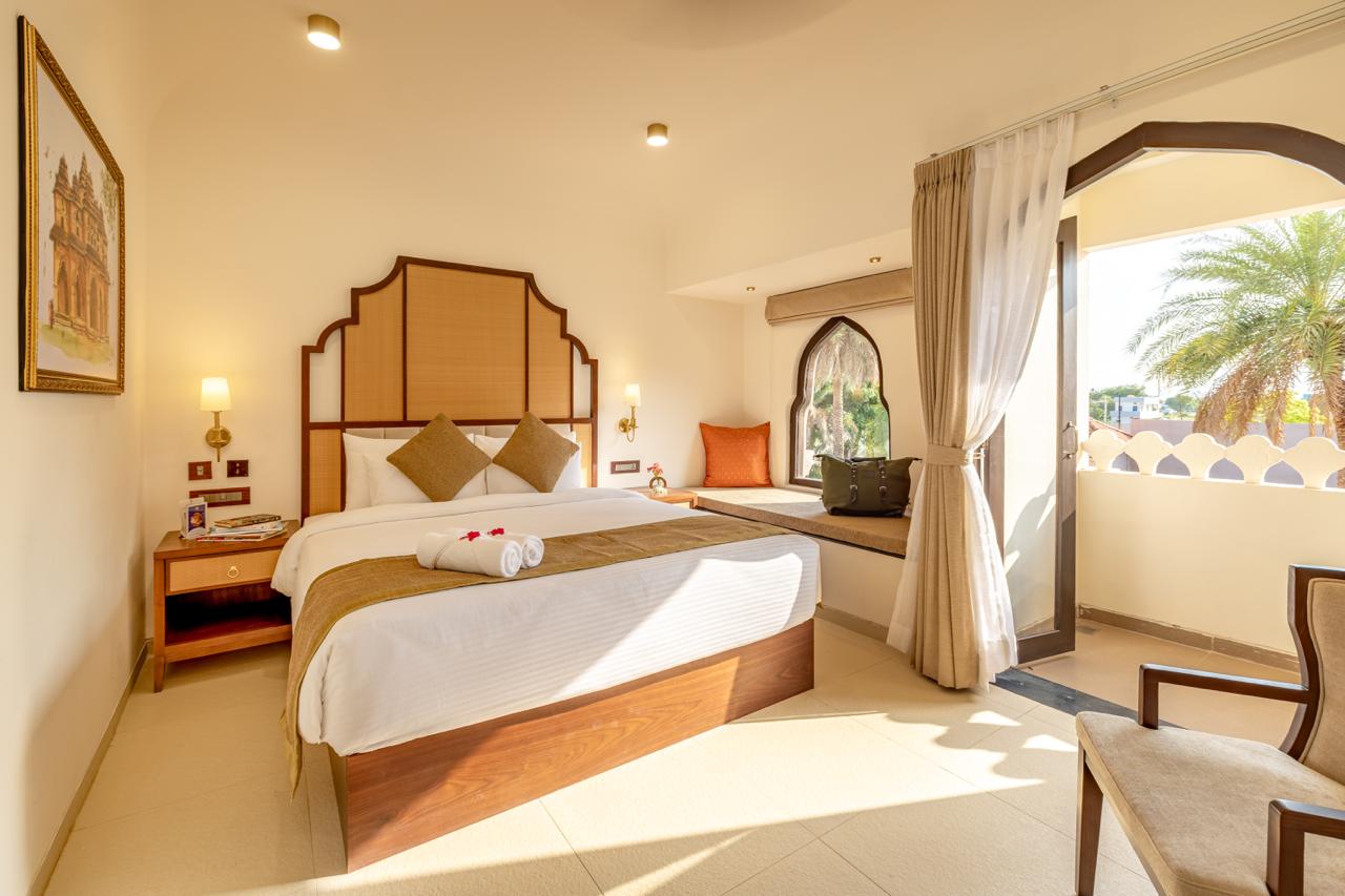Four-poster bed suite with heritage decor at Vijayshree Resort, Hampi